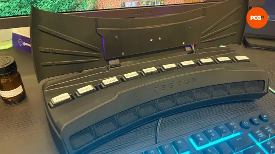 MacBook screen displaying a Minecraft world next to a cloud gaming controller setup