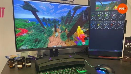 MacBook screen displaying a Minecraft world next to a cloud gaming controller setup