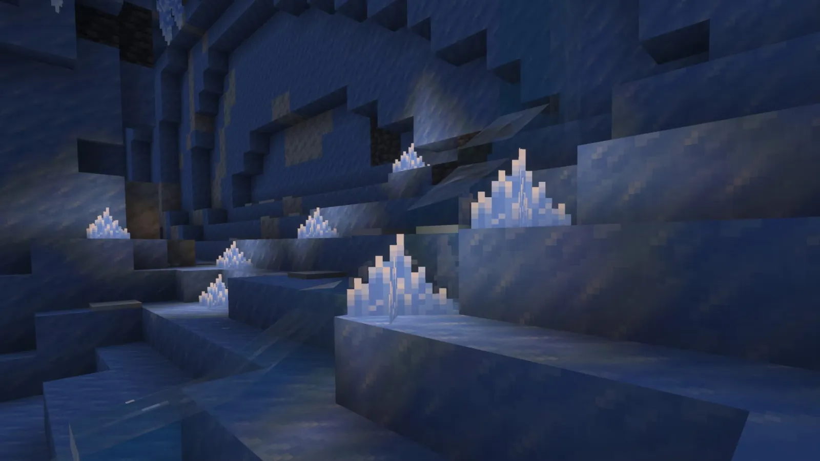 Minecraft player exploring a sparkling ice cave with glowing crystals and fragile icicles